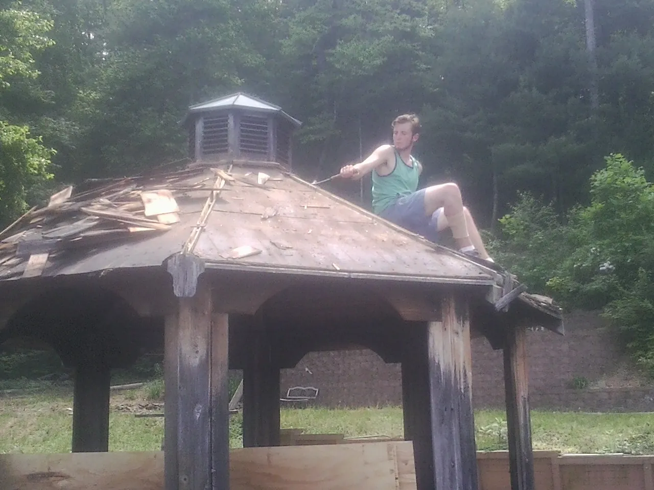 Tearing the old roof off a wooden gazebo before new shakes in San Geronimo