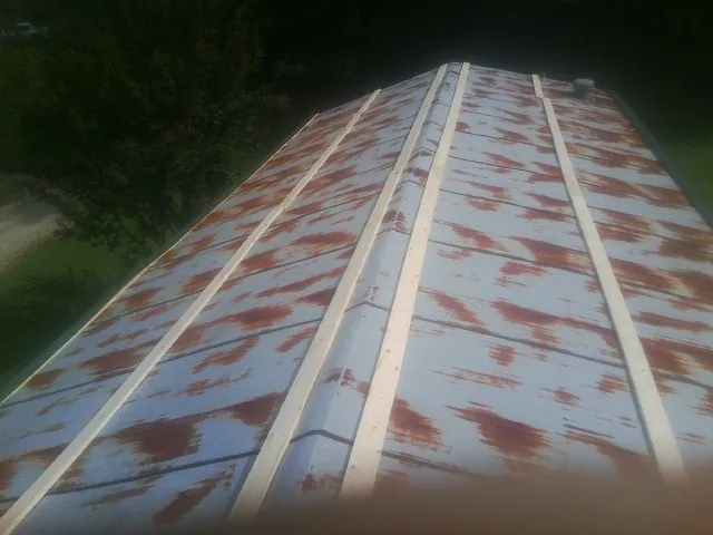 Rusted metal roof panels with new wood purlins before replacement — Storm Damage Roof Repair in San Geronimo by Roofing Brothers