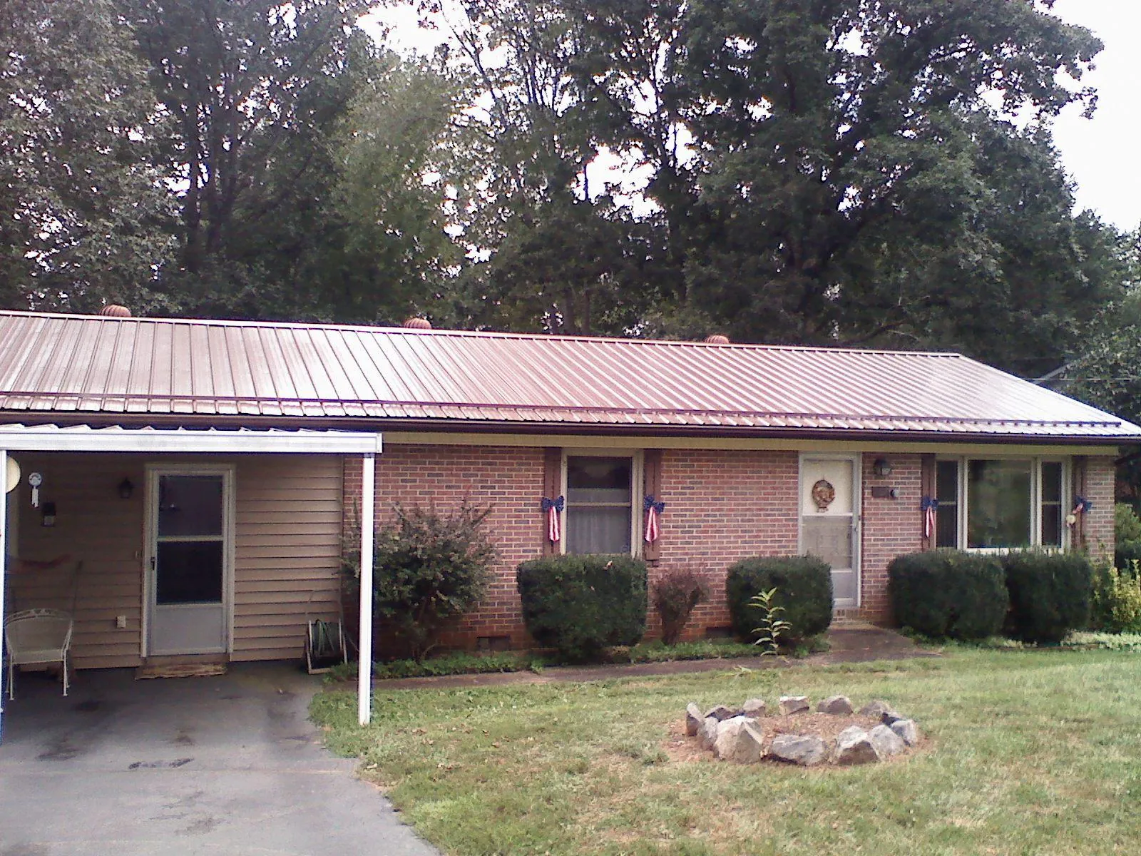 Bronze metal roof and carport on a brick ranch home — Roof Repair work by our crew in San Geronimo